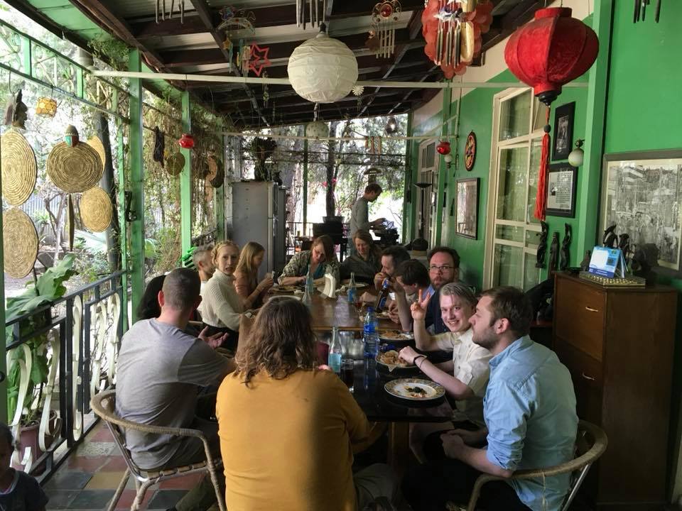 Group dining experience in the green dining room with decorative lanterns