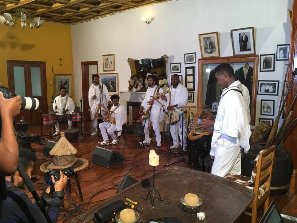 Musicians performing during a cultural production in the villa