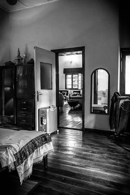 Spacious bedroom with wooden floors and connecting rooms